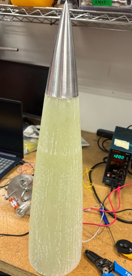 Final fiberglass nose cone with aluminum tip — vertical photo