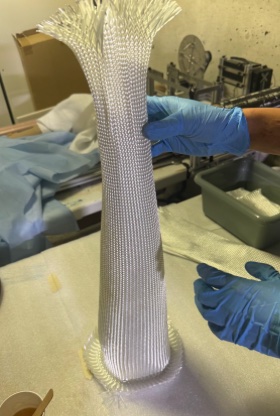 Fiberglass sleeves being applied over mandrel with Aeropoxy